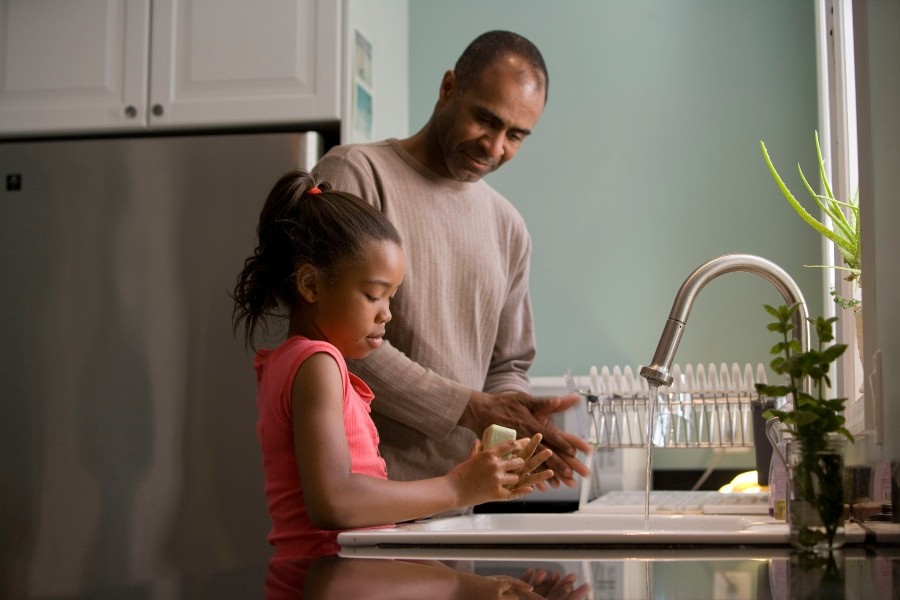 adult and child washing hands adult and child washing hands